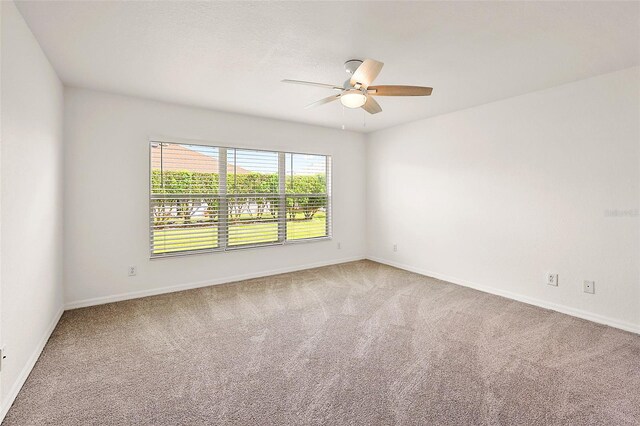 carpeted empty room with ceiling fan