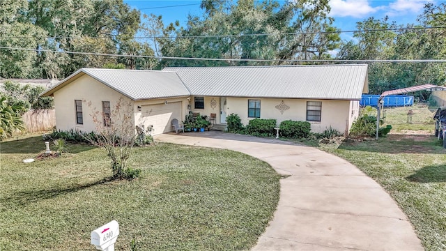 single story home featuring a front lawn and a garage