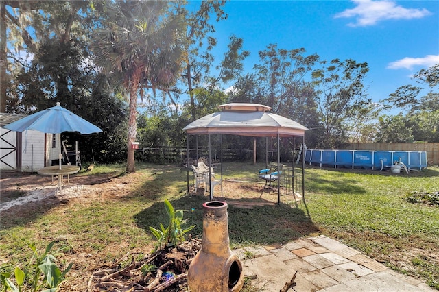 view of yard featuring an outbuilding and a fenced in pool