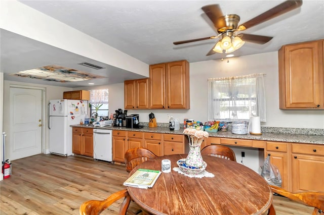 kitchen featuring ceiling fan, light wood-type flooring, light stone counters, and white appliances