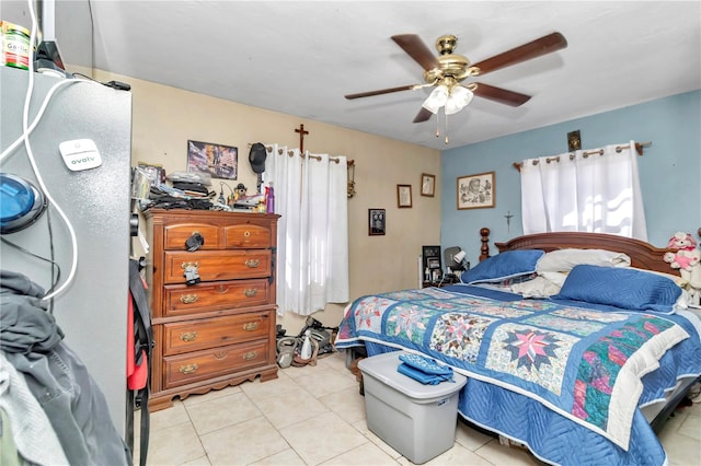 tiled bedroom featuring ceiling fan