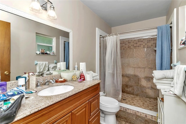 bathroom with toilet, walk in shower, and vanity