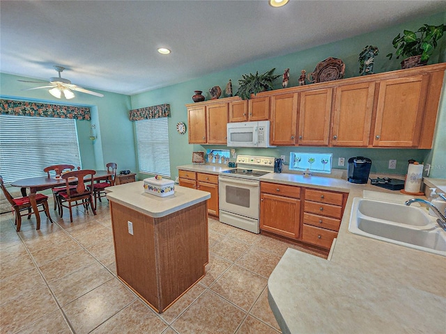 kitchen with white appliances, light tile patterned flooring, sink, and ceiling fan