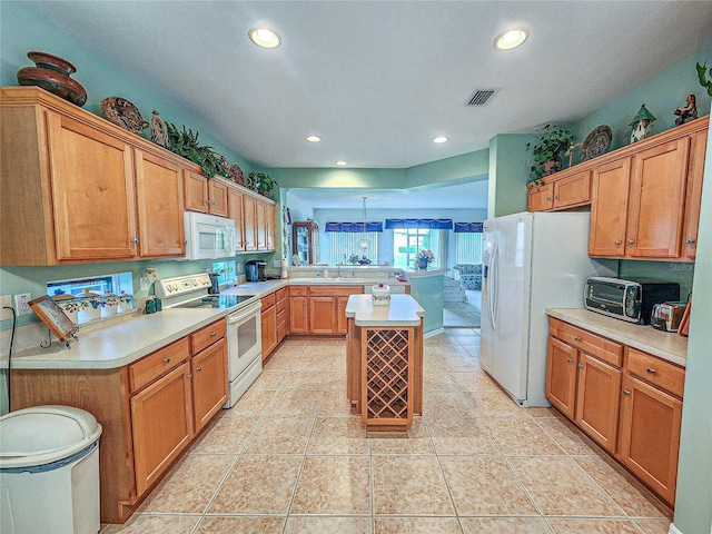 kitchen with kitchen peninsula, sink, light tile patterned floors, and white appliances