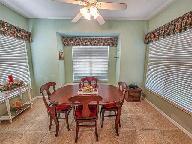 dining area with ceiling fan and light tile patterned flooring