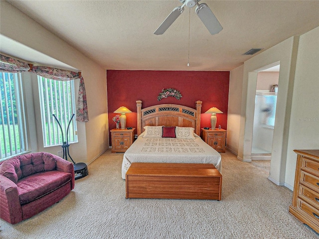 bedroom featuring carpet flooring, ceiling fan, and a textured ceiling