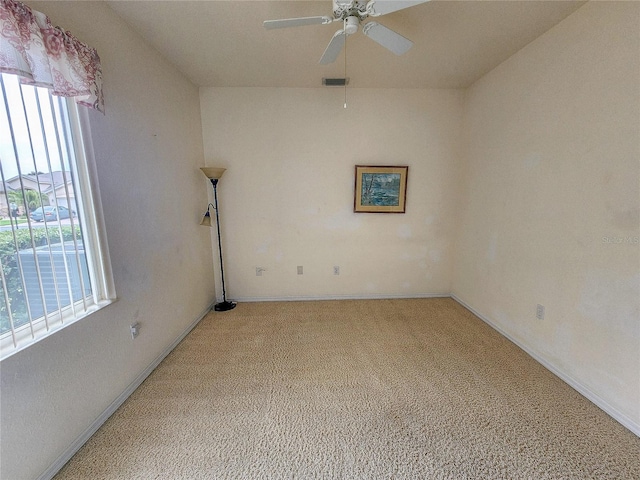 empty room featuring ceiling fan and light carpet