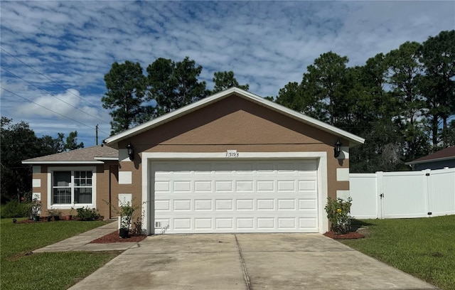 view of front of home with a front lawn and a garage