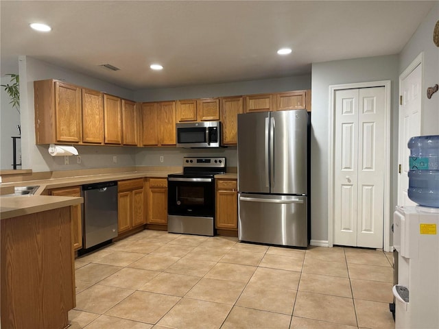 kitchen with stainless steel appliances and light tile patterned floors