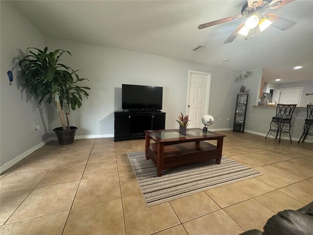 tiled living room with ceiling fan