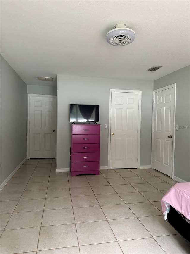 unfurnished bedroom featuring light tile patterned floors