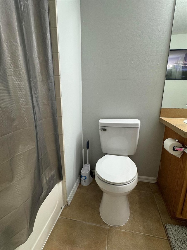 full bathroom featuring vanity, toilet, shower / bath combo with shower curtain, and tile patterned flooring