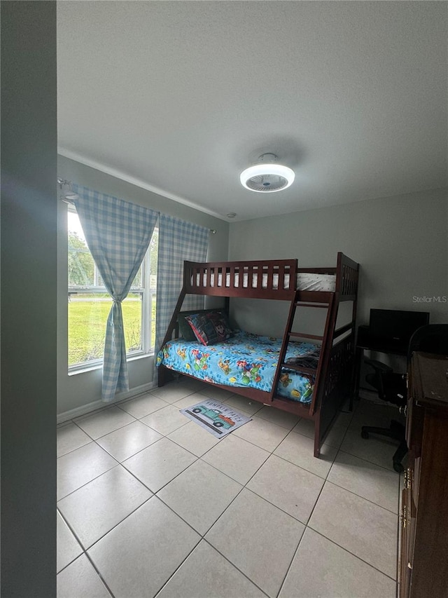 tiled bedroom featuring a textured ceiling