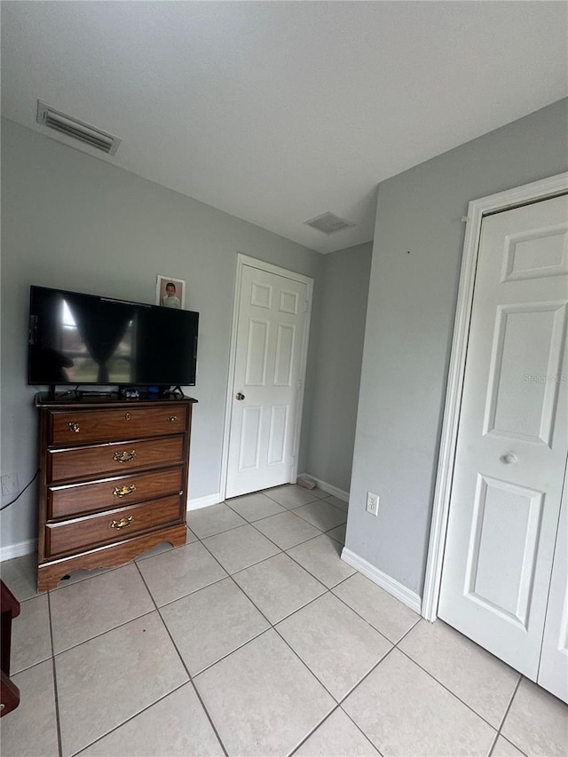 bedroom featuring light tile patterned floors