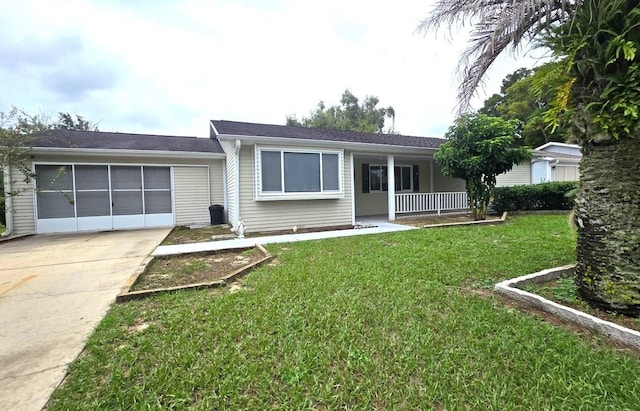 view of front of house featuring a porch, concrete driveway, a front lawn, and an attached garage