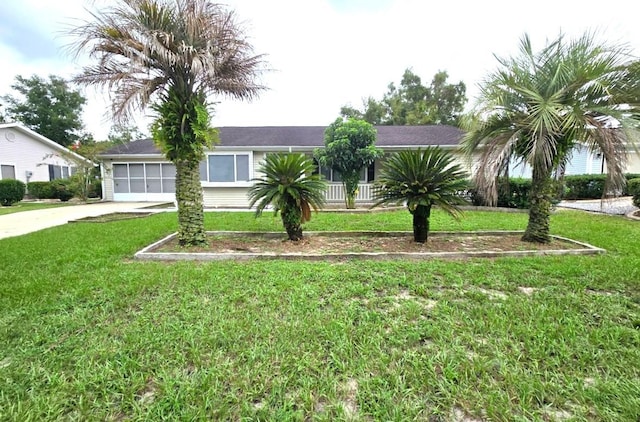 view of front of property featuring a front lawn, driveway, and a garage