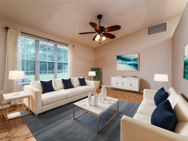 living room with ceiling fan and parquet floors