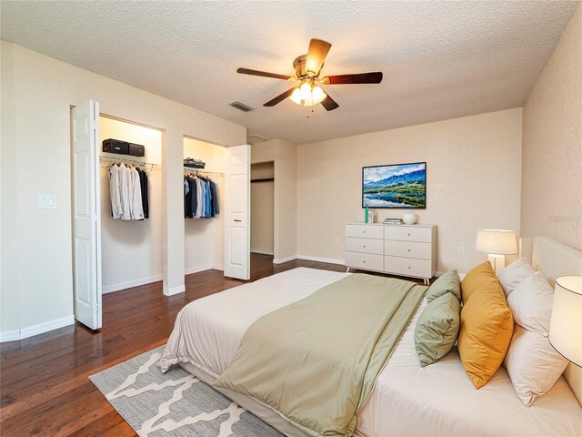 bedroom with dark hardwood / wood-style floors, ceiling fan, and a textured ceiling