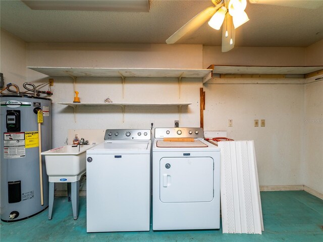 clothes washing area with ceiling fan, electric water heater, sink, and separate washer and dryer