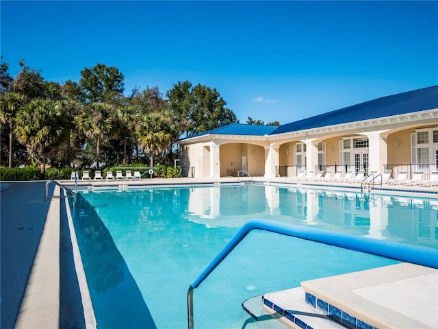 view of pool with french doors and a patio