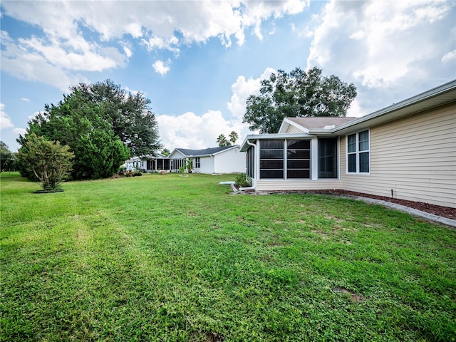 view of yard with a sunroom