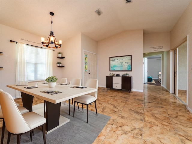 dining space with a textured ceiling, lofted ceiling, and an inviting chandelier