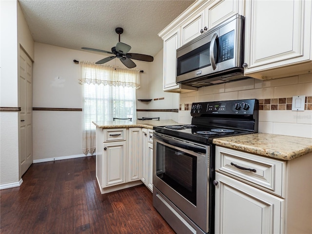 kitchen with white cabinetry, ceiling fan, dark wood-type flooring, a textured ceiling, and appliances with stainless steel finishes