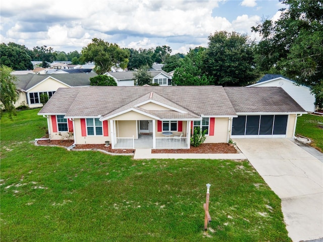 single story home featuring a sunroom, a porch, and a front yard