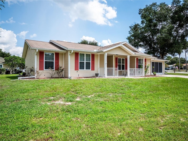 ranch-style home with covered porch, a garage, and a front lawn