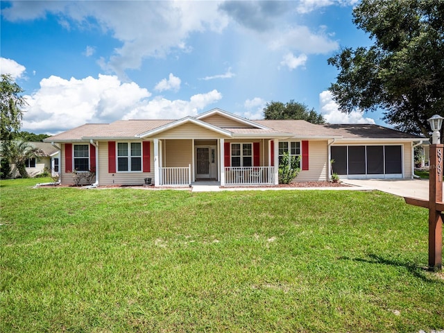 single story home featuring a front lawn, covered porch, and a garage