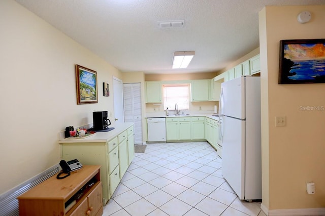 kitchen featuring white appliances, a textured ceiling, light tile patterned flooring, and sink