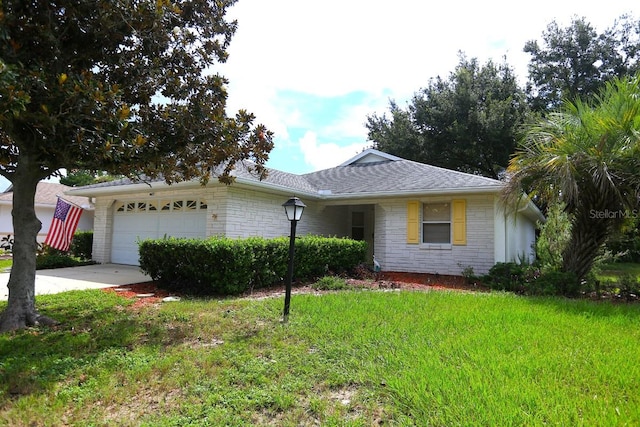 single story home featuring a garage and a front lawn