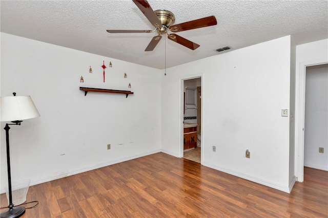 unfurnished room featuring ceiling fan, a textured ceiling, and dark hardwood / wood-style flooring