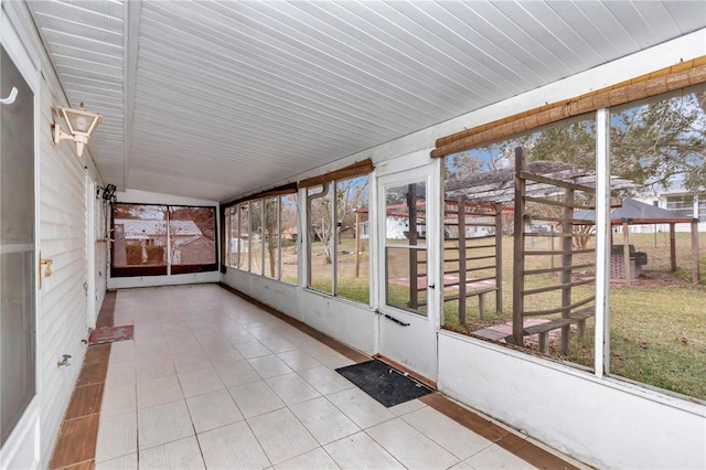 unfurnished sunroom with lofted ceiling