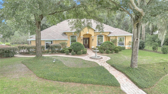 mediterranean / spanish-style house with a front lawn