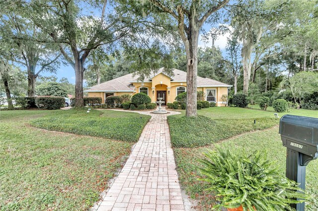 ranch-style home with a front lawn