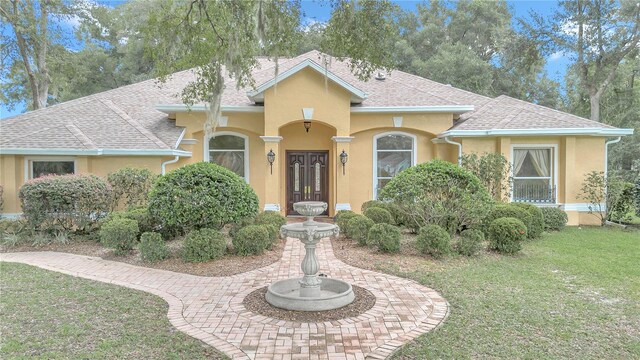 view of front of house featuring french doors and a front yard