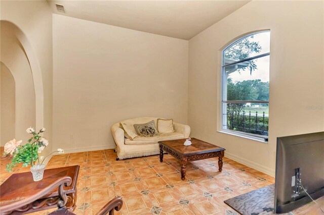 living room featuring a wealth of natural light and light tile patterned floors