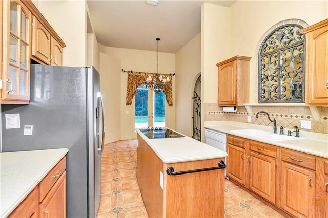 kitchen featuring an inviting chandelier, sink, black electric stovetop, a kitchen island, and decorative backsplash