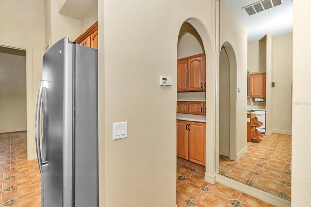 kitchen with stainless steel fridge and light tile patterned flooring