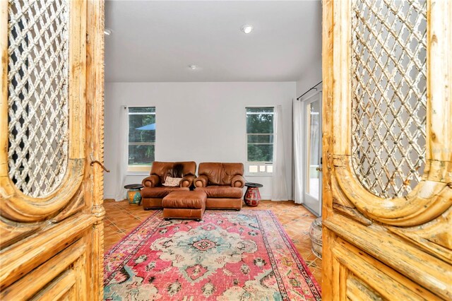 living room with plenty of natural light and light tile patterned floors