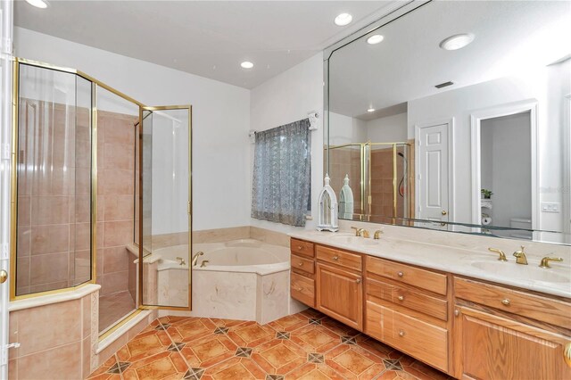 full bathroom with vanity, toilet, plus walk in shower, and tile patterned flooring