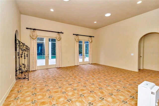 interior space featuring french doors, plenty of natural light, and light tile patterned floors