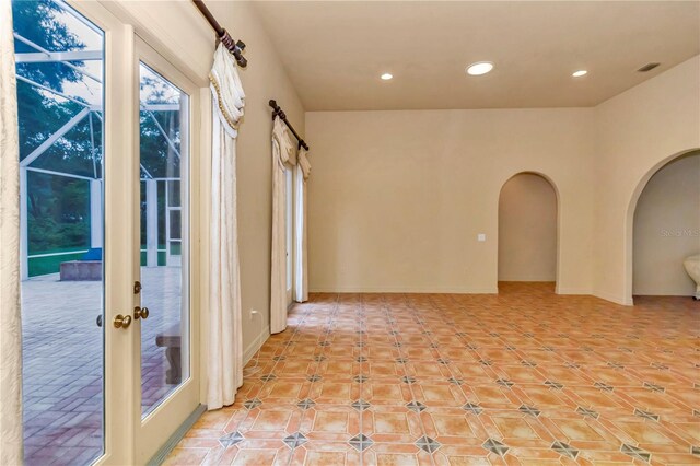 unfurnished room featuring french doors