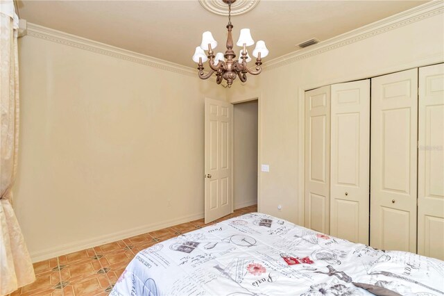 bedroom featuring a closet, a chandelier, and ornamental molding