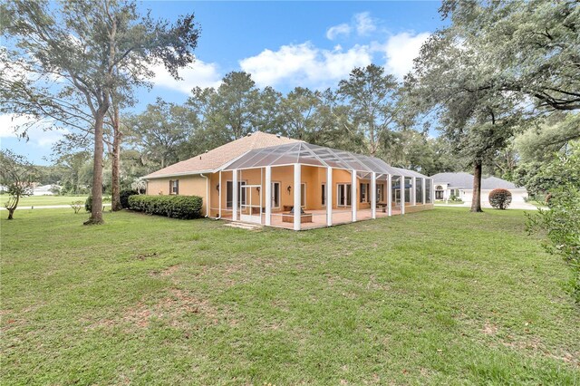 rear view of house with a lawn and a patio area