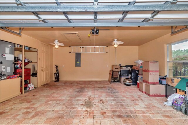 garage featuring a garage door opener, ceiling fan, and electric panel