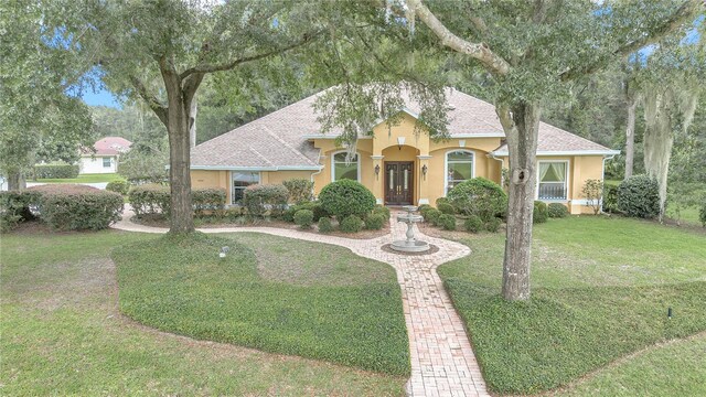 mediterranean / spanish-style home featuring a front yard