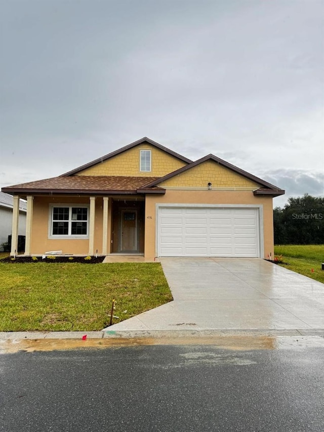 view of front of property featuring a garage and a front yard