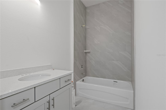 bathroom with tiled shower / bath combo and vanity